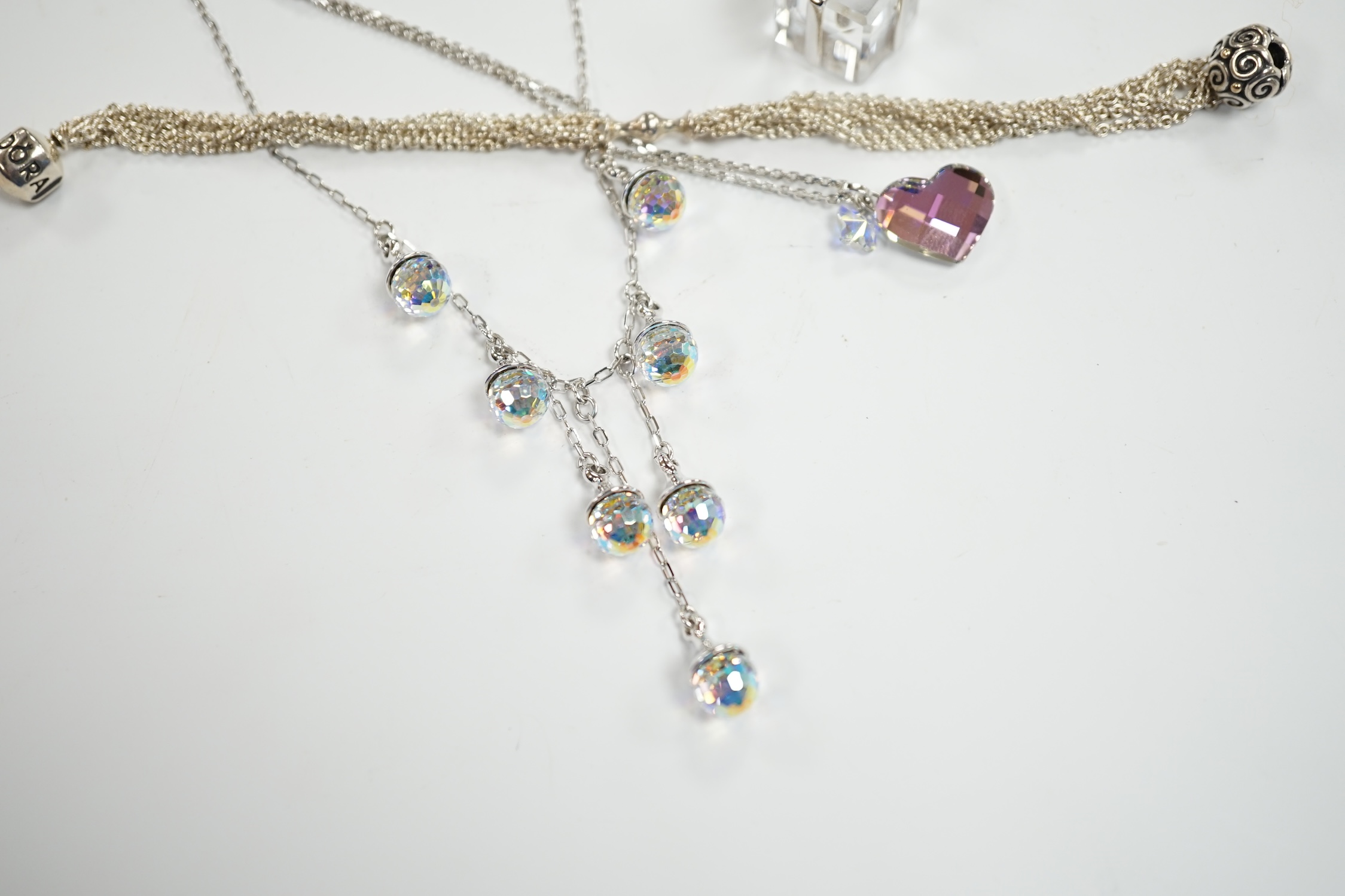 Two modern Swarovski crystal necklaces, a similar 'present' charm and a Pandora bracelet.